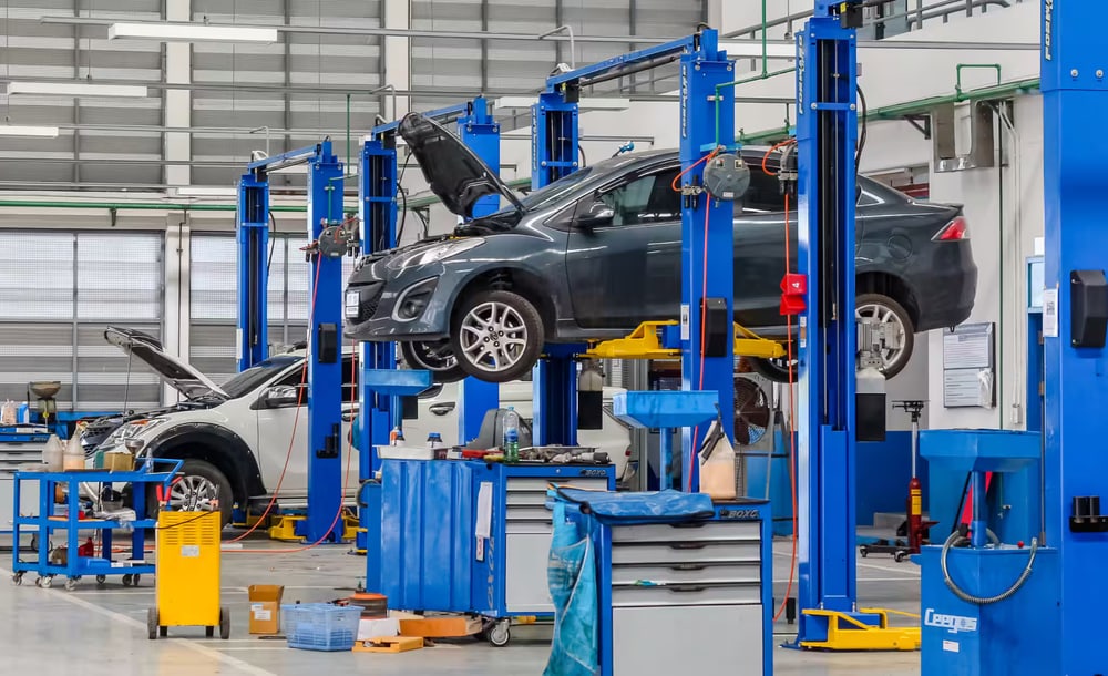 Mechanic shop with cars raised on vehicle lifts